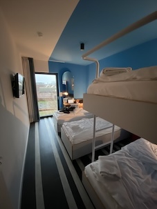 A hostel room with 4 beds, 2 bunk beds